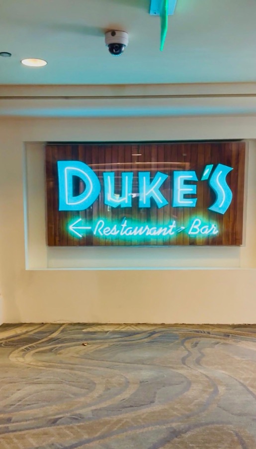 Duke's Restaurant and Bar neon sign glowing teal