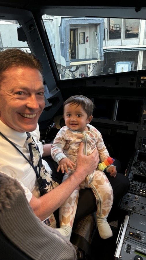 Gia sitting in the pilot's seat in the cockpit at Oahu