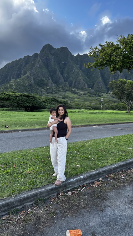 Kanak holding Gia in front of the dramatic Ko'olau mountains