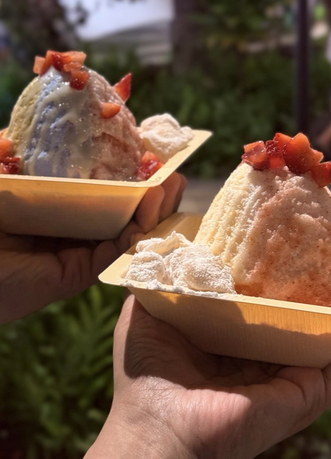 Two enormous Heavenly Liliko'i shaved ices held up in wooden trays